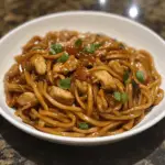 A bowl of Easy Chicken Chow Mein featuring tender chicken, stir-fried noodles, and colorful vegetables in a savory sauce.
