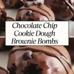 Rich chocolate chip cookie dough brownie bombs coated in smooth chocolate and topped with chocolate chips, with one partially bitten to reveal the gooey inside.