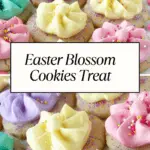 Soft sugar cookies decorated with pastel-colored buttercream, sprinkles, and sanding sugar, arranged on a plate with colorful candy.